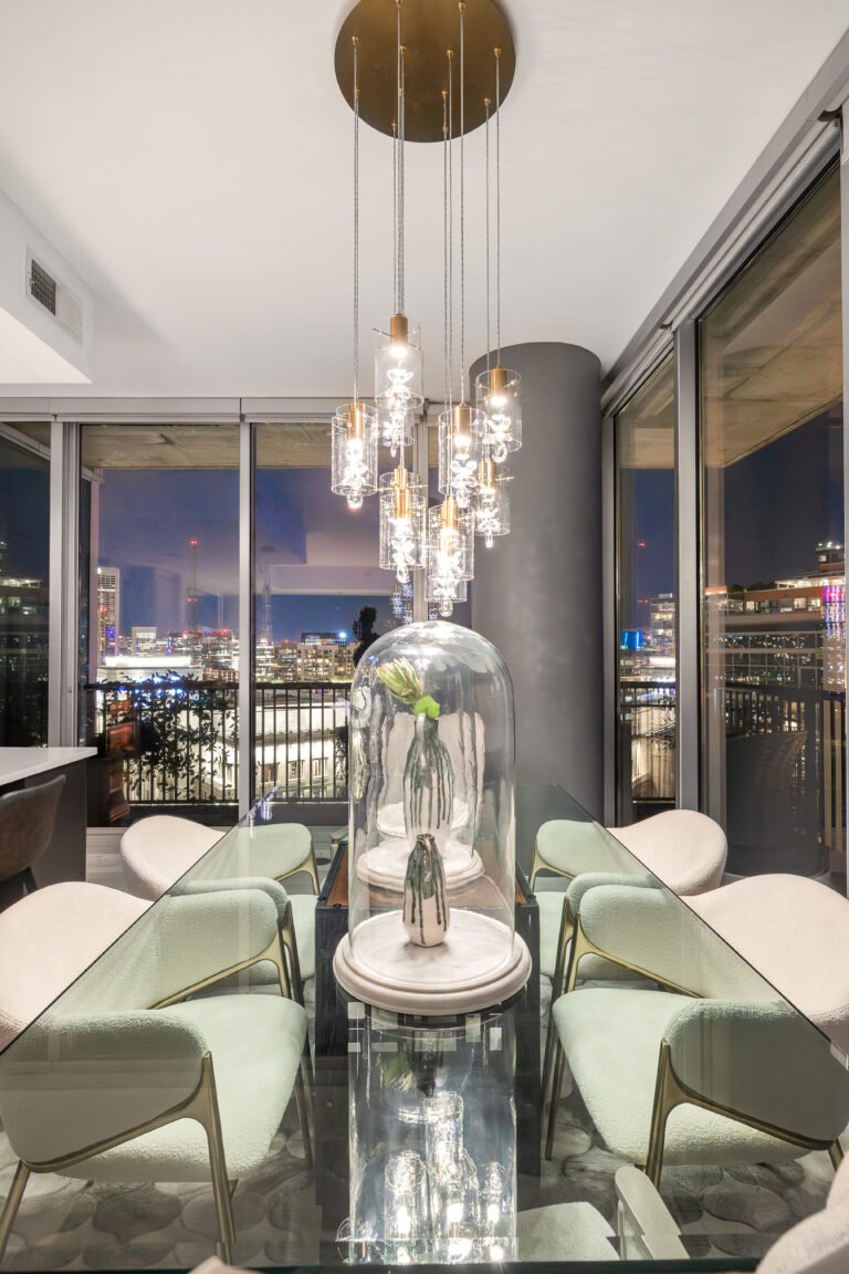 Dining table with sage chairs under crystal pendants
