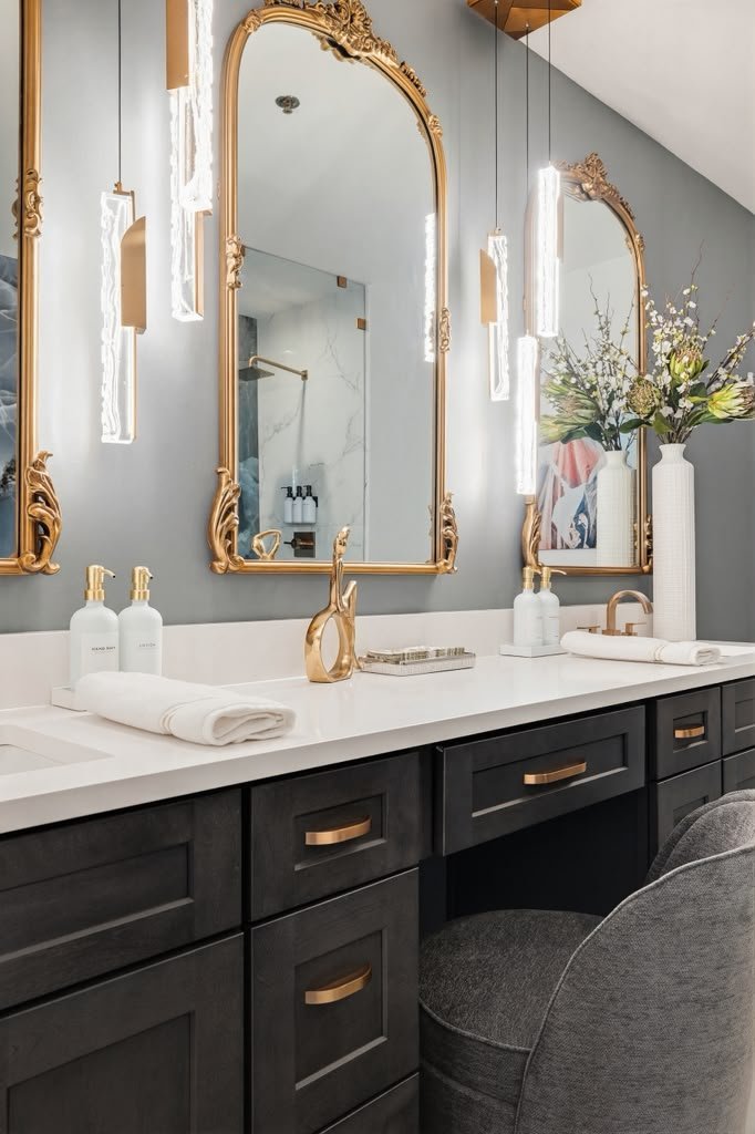 Vanity with brass fittings and a seated makeup station