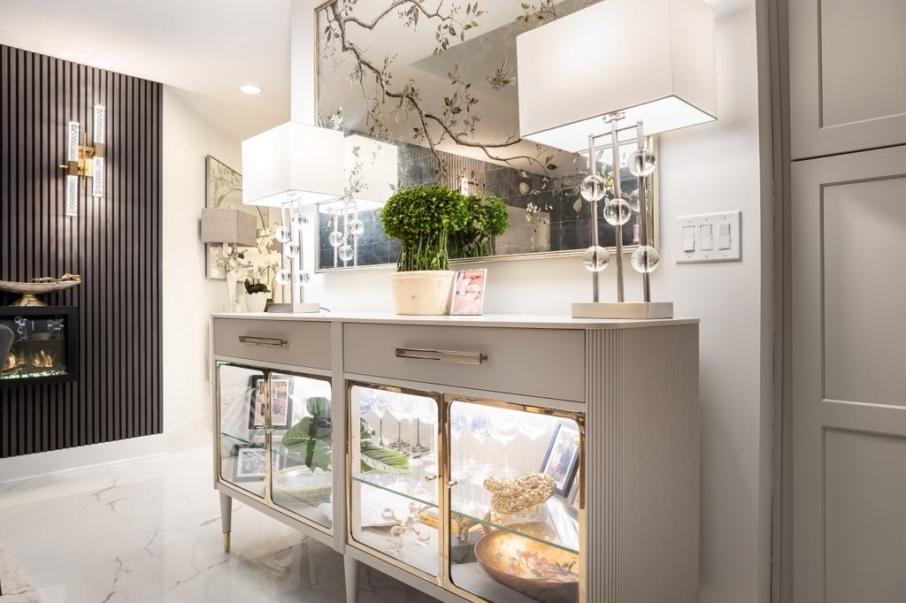 Lit glass console beside the fluted wall