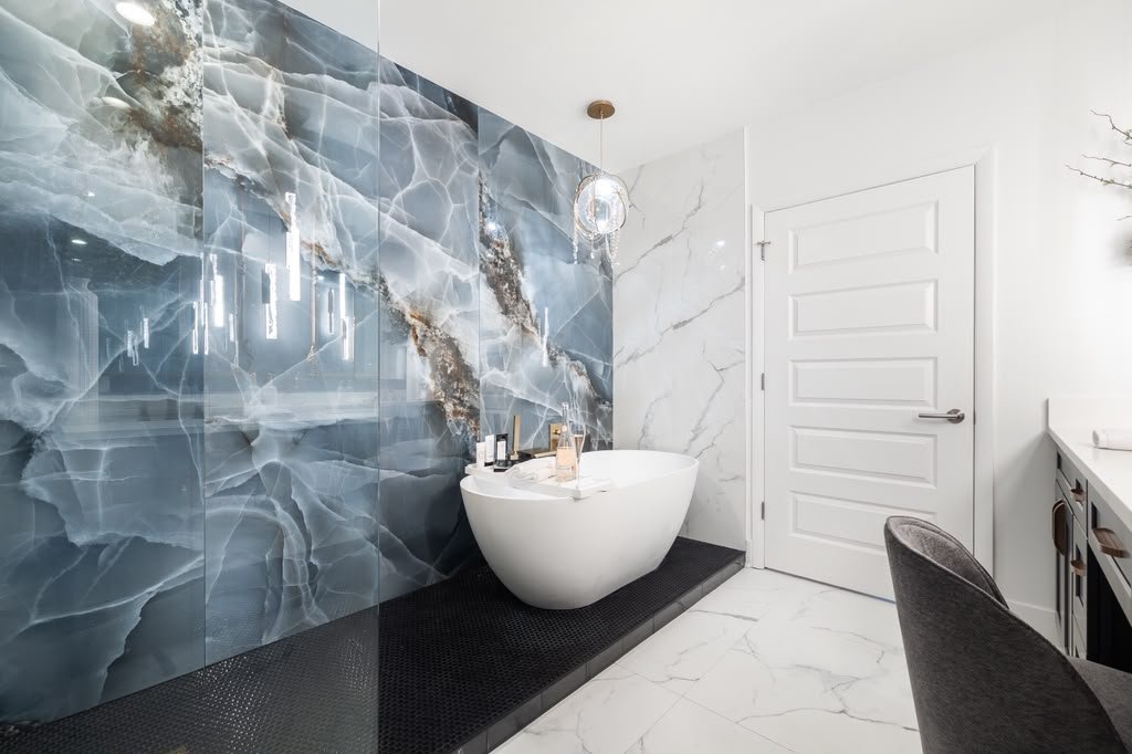 Freestanding tub against a blue onyx wall