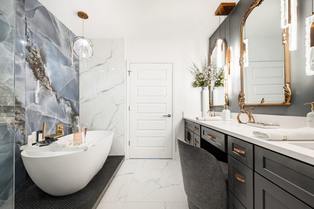 Primary bathroom after the redesign, with a blue onyx wall, a freestanding tub and gilt arched mirrors