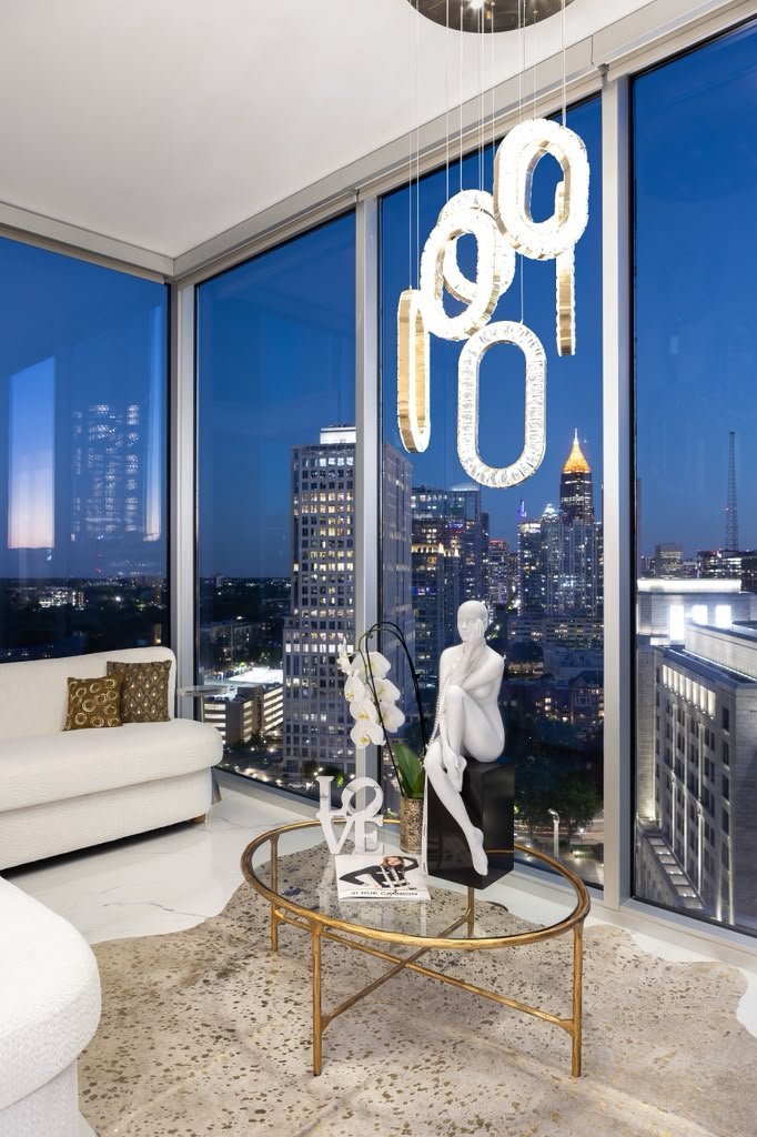 Corner living room with floor-to-ceiling glass and a crystal ring chandelier
