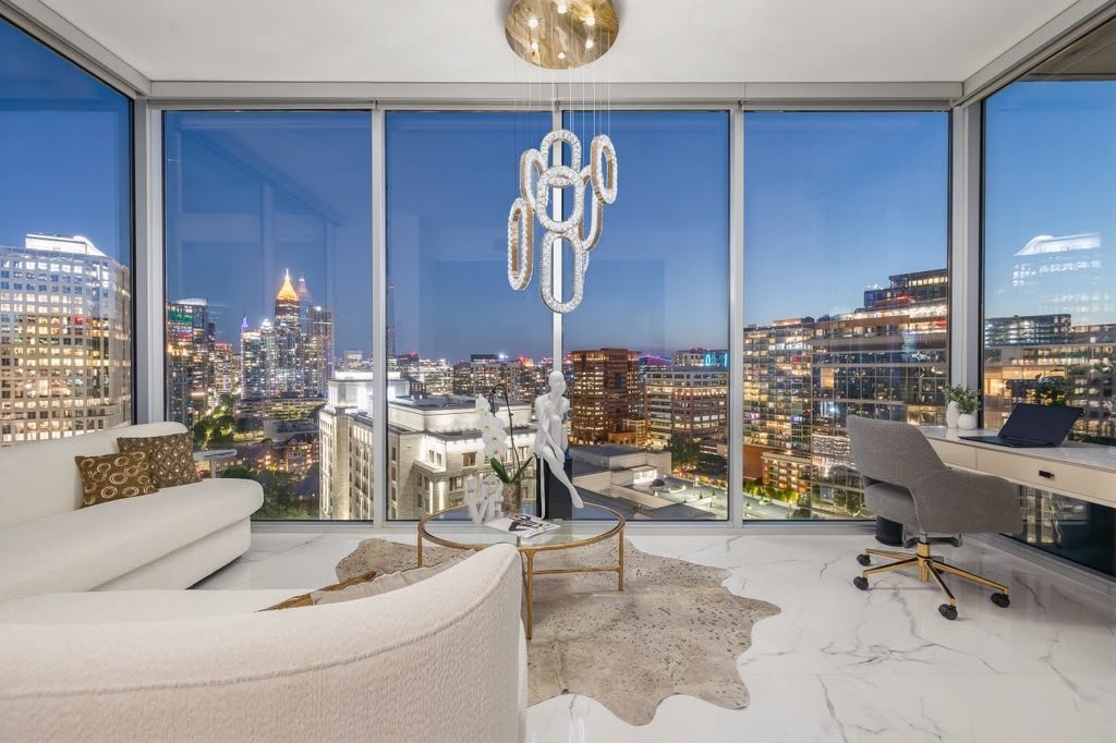 Living room with two walls of glass overlooking the city